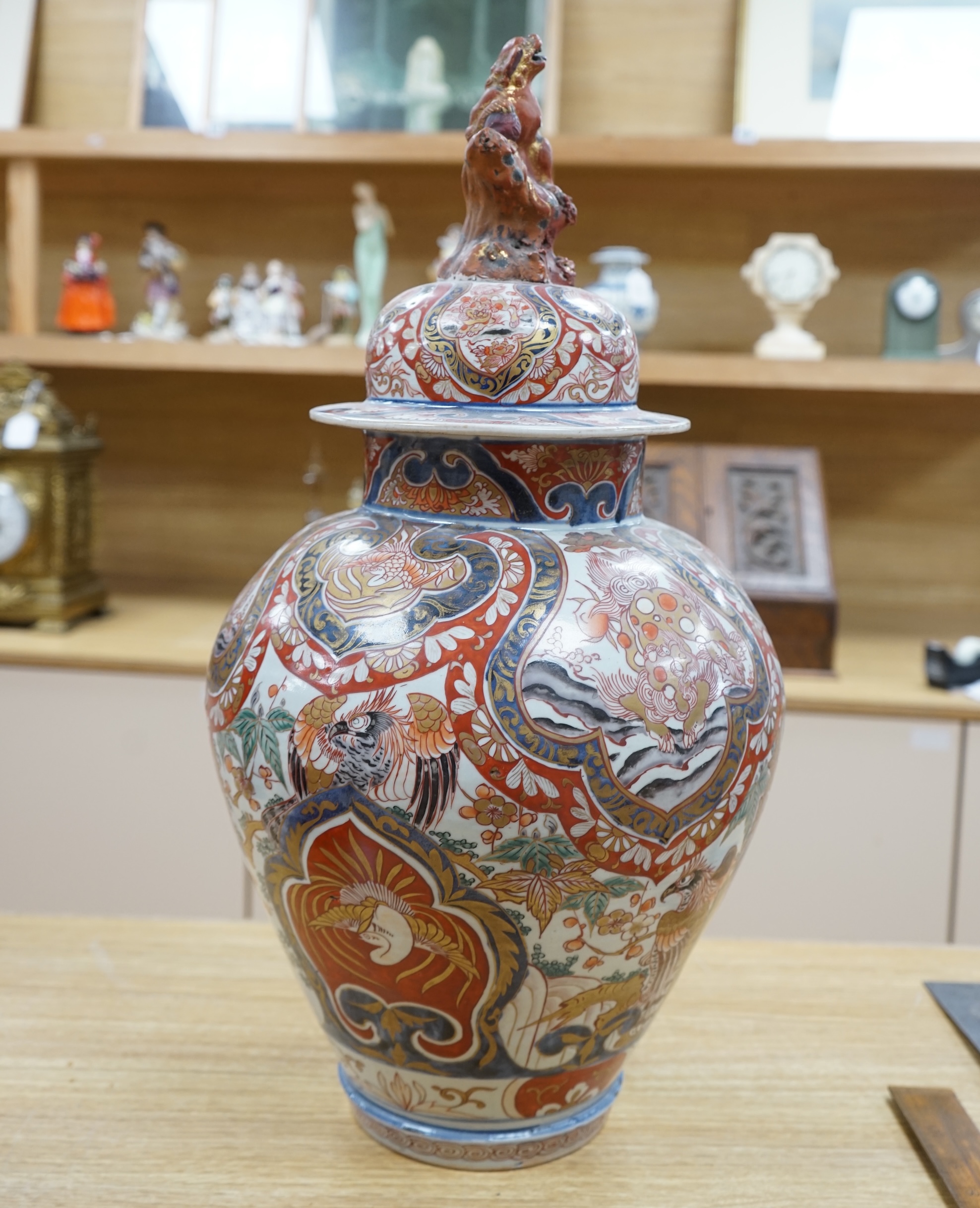 A large 19th century Imari vase with dragon finial to cover, 61cm high. Condition - badly cracked and restored